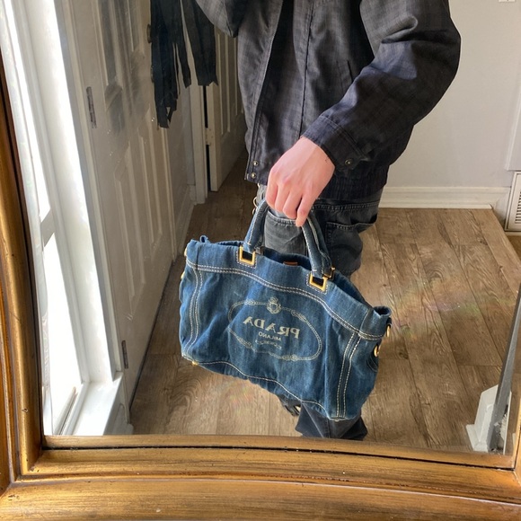 This is a Prada denim tote bag. No rips or tears, just minor wear from use. - Picture 8 of 9